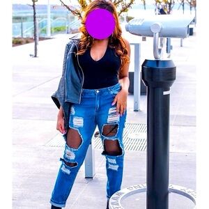 Blue ripped jeans with black mesh.